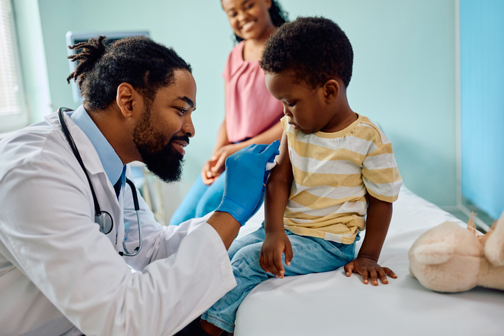 Doctor helping a child.