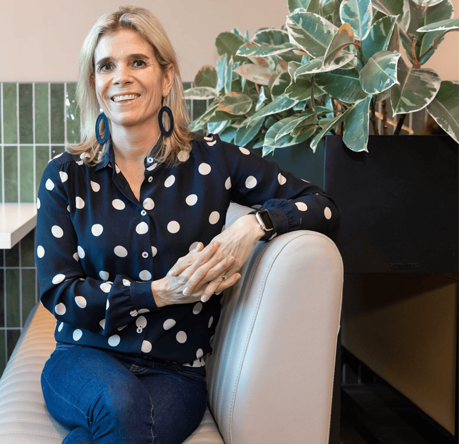 Photo of Juul te Veldhuis, a blonde woman wearing dark blue trousers with white polka dots and a denim jacket.